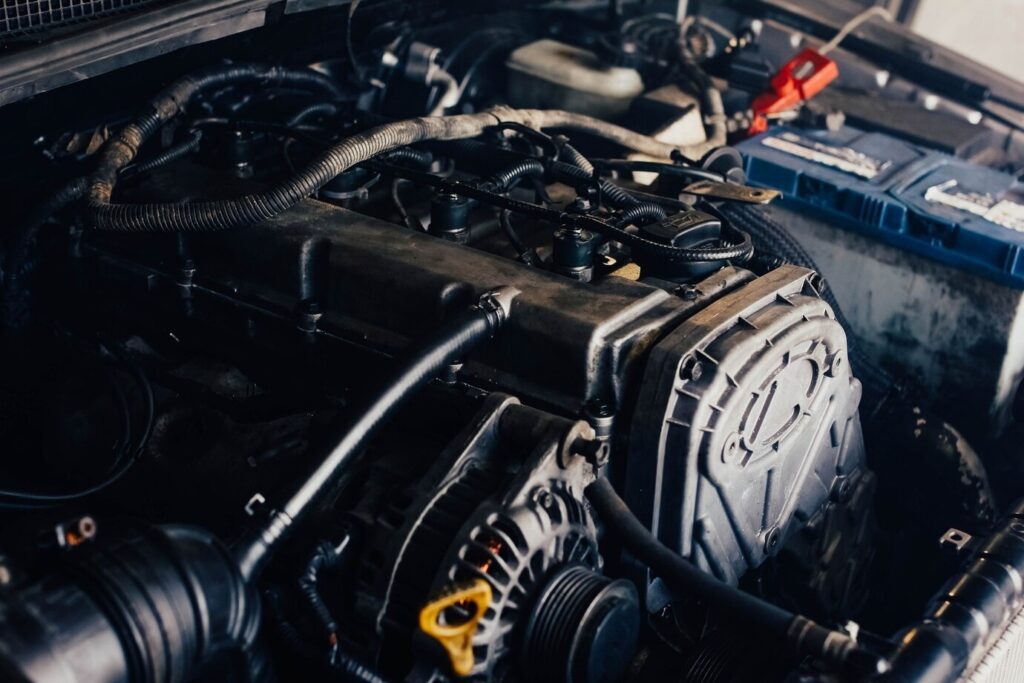 Close-up of a car engine with wires and components under the hood.